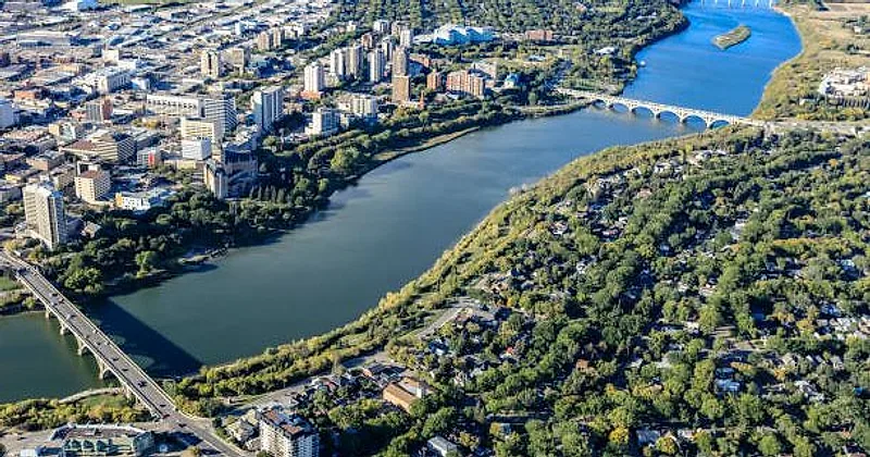 Aerial view of the South Saskatchewan River winding past downtown Saskatoon and the Nutana neighbourhood